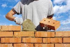 11432552-bricklayer-laying-bricks-to-make-a-wall-Stock-Photo-bricklayer-builders.jpg