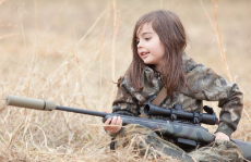 6 year old girl with a sniper rifle.jpg