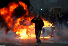 7193864-6477953-A_car_burns_during_clashes_with_police_at_a_demonstration_of_the-a-4_1544433255026.jpg