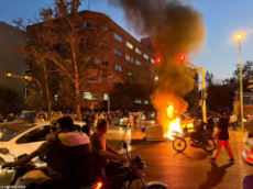 62725129-11242765-A_police_motorcycle_burns_during_a_protest_over_the_death_of_Mah-a-141_1663938828936.jpg
